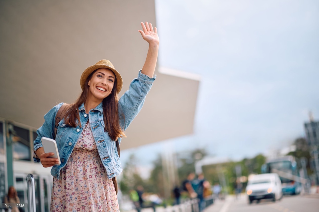 A girl happily waving for the car driver