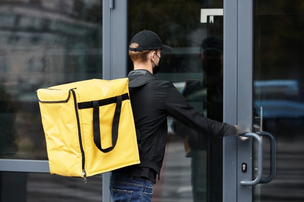 delivery employee at a company doorstep